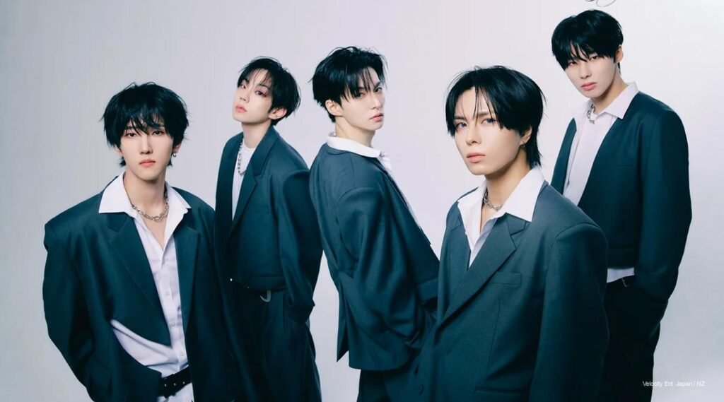 E’LAST in “Tame” concept photos: group in navy blazers and white shirts, individuals with leather gloves and intense gazes, capturing K-pop maturity and emotional tension.