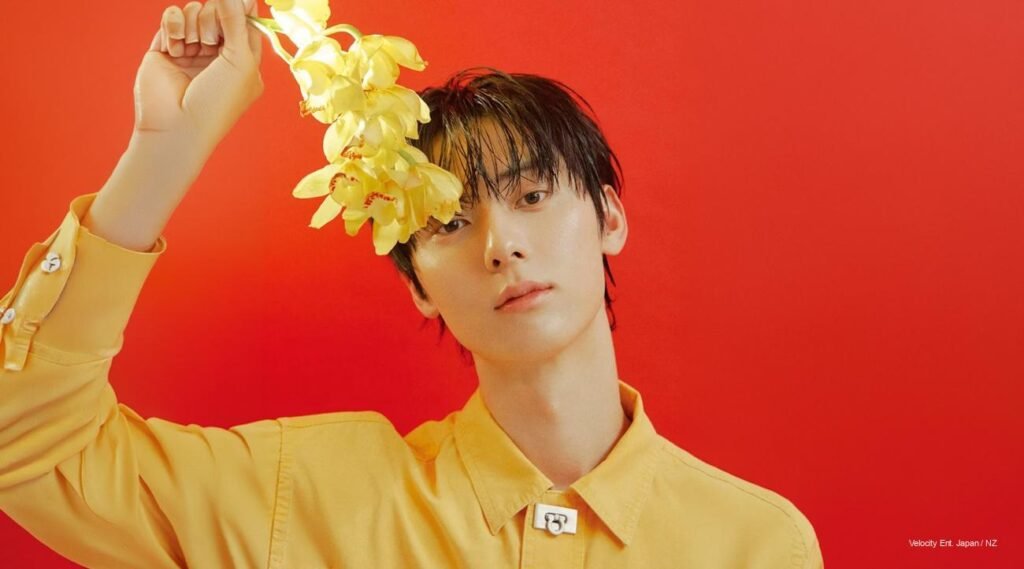 Hwang Minhyun posing for Singles Korea April 2026 cover, embodying minimalist elegance in black tailoring.