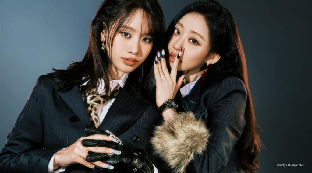 KISS OF LIFE “Who Is She” Suspicion #1 concept photo with the members in dark pinstripe suits, leather gloves, and candlelit noir styling.