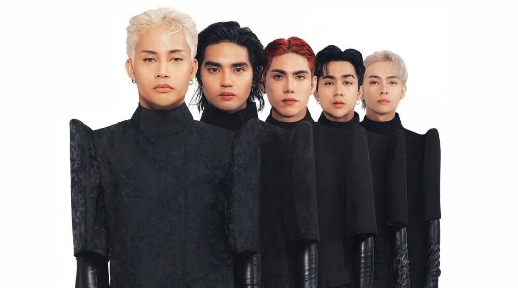 SB19 in sleek black suits, powerful group pose symbolizing strength and style evolution.