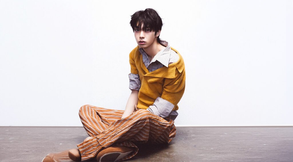 Liyu & Woojin, FNC’s new K‑pop duo, styled in matching monochrome tailoring under a neon‑lit urban night for DAZED Korea April 2026.