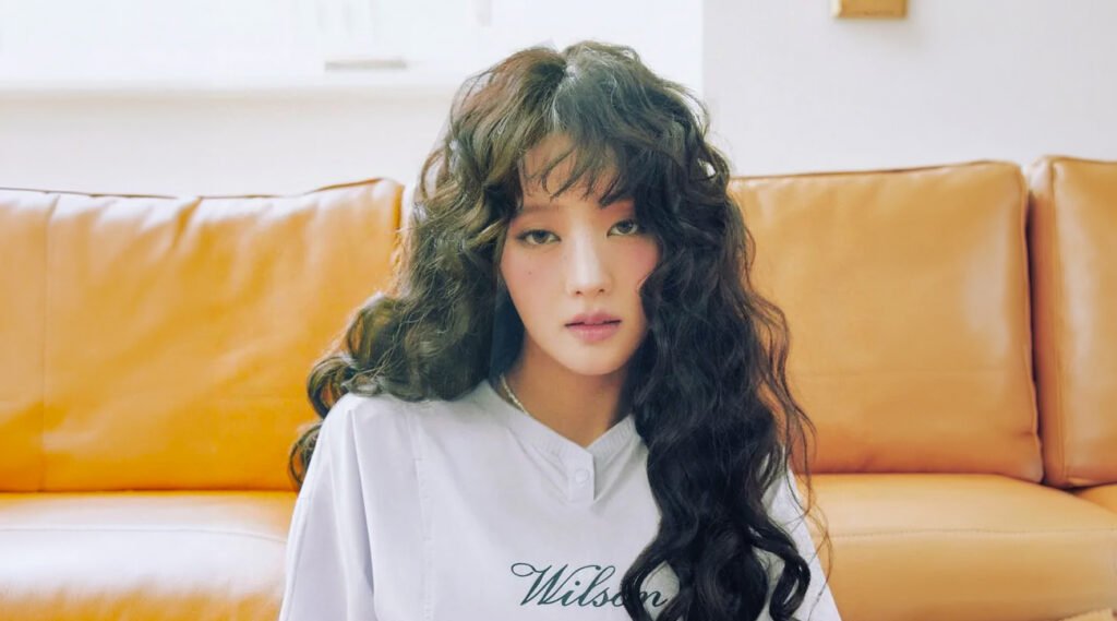 i-dle Minnie in white Wilson athletic wear for Cosmopolitan Korea Sports Wellness cover, posing confidently with trophies