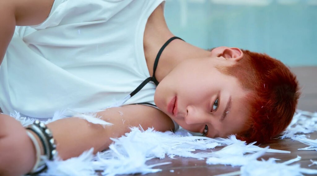 Park Jihoon gazes into soft golden light with orange hair for RE:FLECT concept photo, symbolizing introspection and artistic rebirth.