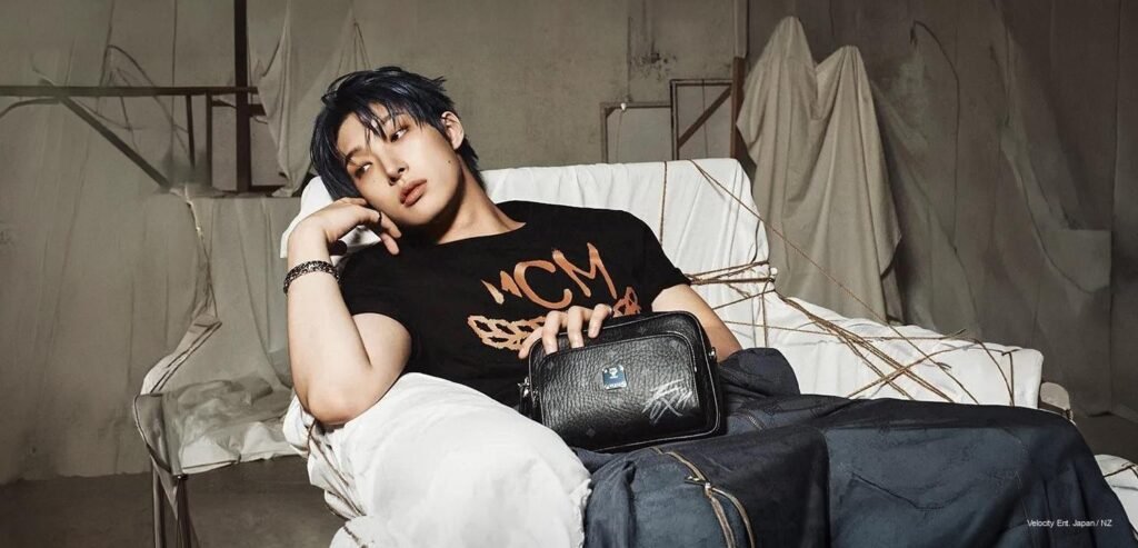 Mingi of ATEEZ in MCM FIX ON collaboration campaign 2026, wearing luxury monogram leather jacket, direct gaze, cinematic editorial lighting