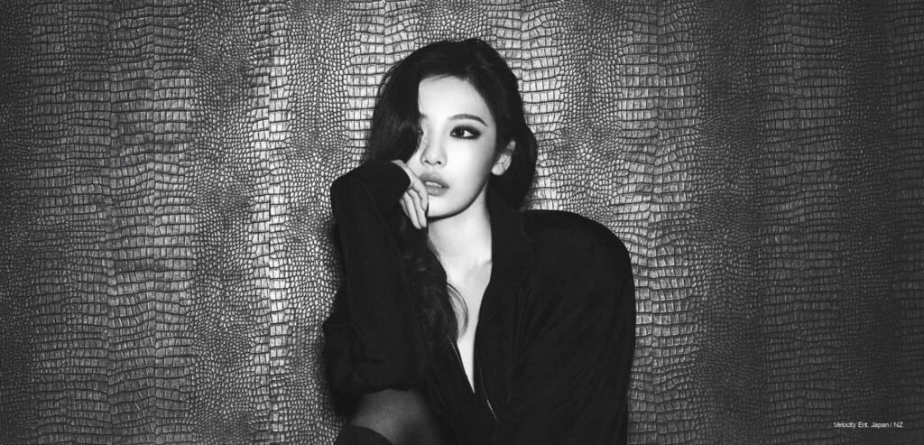 NINGNING of aespa in a black Gucci jacket with Bvlgari jewellery for Marie Claire China May 2026 cover shoot, photographed against a dark teal textured background.