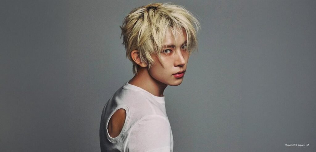 EVAN in a W Korea July 2026 pictorial, presenting a stripped-back, fashion-forward solo debut image.
