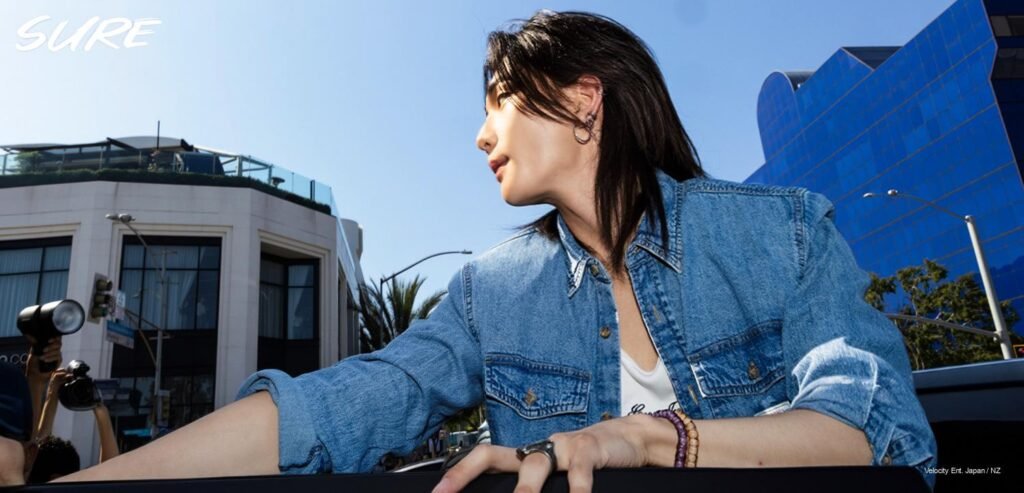 Hyunjin waves to STAYs at GUESS Jeans Melrose Pop-Up Hyunjin of Stray Kids in GUESS Jeans Regular Denim Shirt and Relaxed Heritage Jeans (medium wash) on Melrose Avenue, Los Angeles, for Sure Magazine June 2026