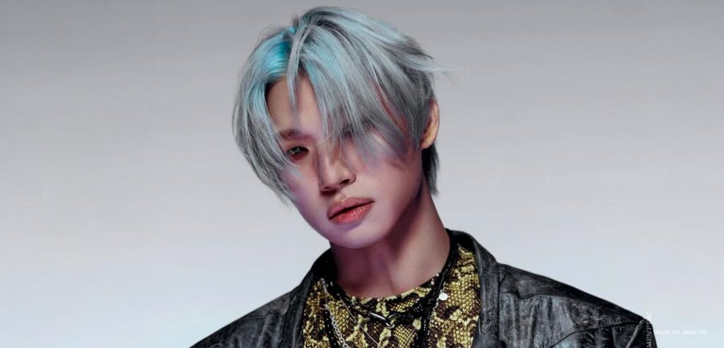 BIGBANG member in silver hair and patterned styling from the “BiiiG” visual photos, photographed in a stark editorial close-up.