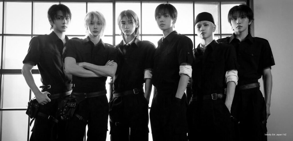 BOYNEXTDOOR six members in black tactical-inspired styling backlit for "Boom Boom Boom" Japanese single
