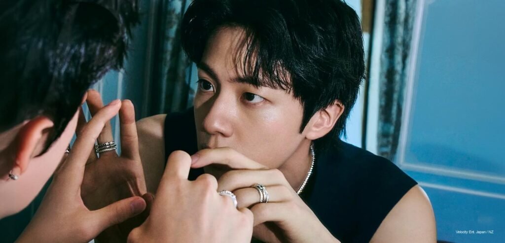 Jin x FRED — ELLE Korea August 2026 Digital Cover BTS Jin resting his chin on his hand, reflected in a mirror, wearing FRED silver rings and a dark sleeveless top, for ELLE Korea's August 2026 digital cover