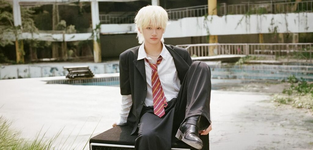 Splayit ‘SPLAY : CHAPTER 01’ concept photos Splayit member seated in a blue-tiled set wearing a white shirt, striped tie, and school-uniform-inspired styling for the ‘SPLAY : CHAPTER 01’ concept photo.