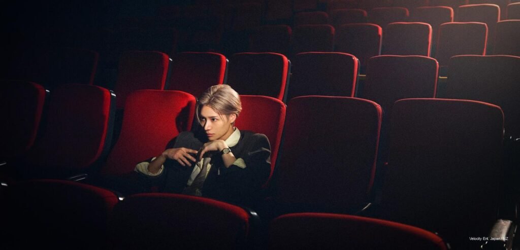 Taemin seated in a red theater seat for the 2026-27 LiMiNaL world tour announcement, with Latin America dates listed beside him.