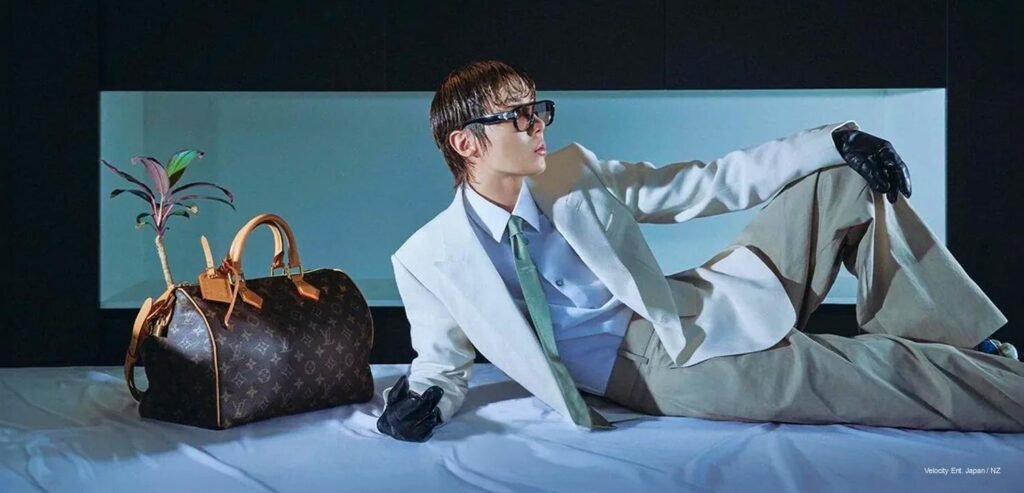 BTS j-hope reclines in an ivory tailored suit beside a Louis Vuitton monogram Speedy bag for GQ Korea's September 2026 issue