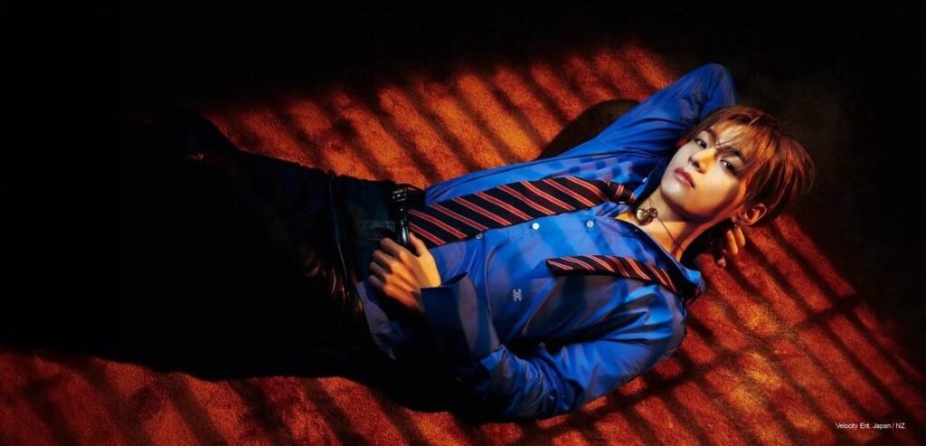 BTS V Kim Taehyung lying on carpet under slotted shadows wearing a royal blue Celine shirt and tie for Dazed Autumn 2026 cover shoot