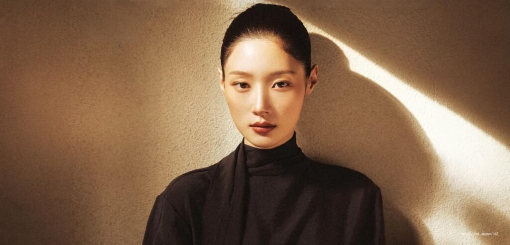 Jung Chaeyeon posing for WWD Korea x COURONNE October 2026 Issue against a warm minimalist backdrop.