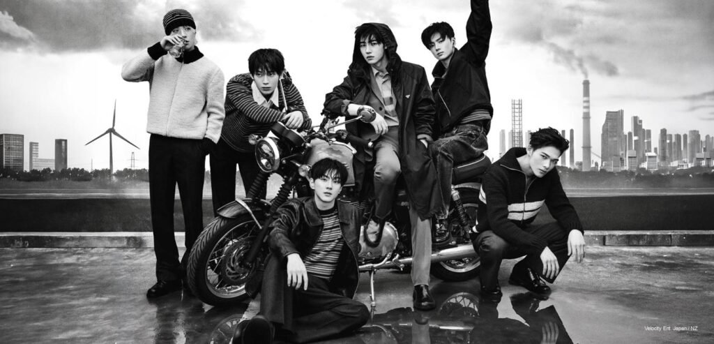 ENHYPEN Marie Claire Korea 2026 ENHYPEN members posed in high-fashion Prada tailoring around a vintage motorcycle against a moody industrial skyline for Marie Claire Korea Cover.