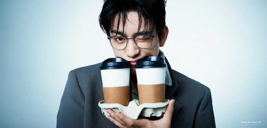 GOT7 Park Jinyoung wearing wire-rim glasses and holding two coffee cups in his mouth for Cosmopolitan Korea November 2026 issue.