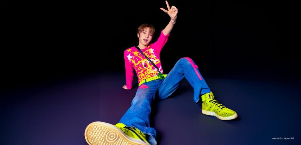 NCT WISH I SPY Concept Photos NCT WISH member posing in neon pink shirt, blue jeans, and volt green sneakers against a dark background for I SPY mini album concept.