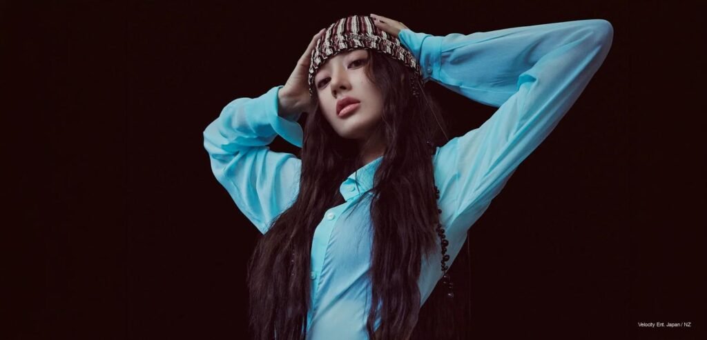 TWICE Jihyo wearing a sky-blue silk shirt and knit beanie posing against a dark background for Harper's BAZAAR Korea