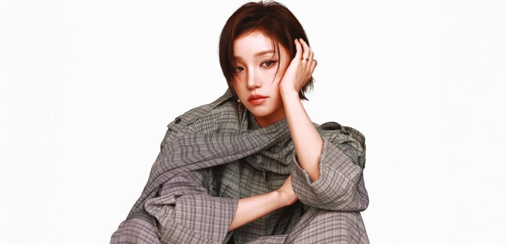 Song Yuqi posing in a structured Tory Burch plaid outfit for Vogue Hong Kong October 2026 cover story.